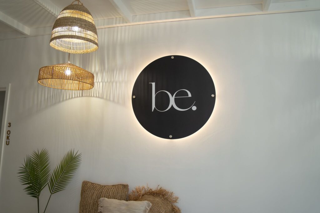 Stylish interior of a laser and skin clinic, featuring a decorative plant and elegant signage. Modern and welcoming ambiance for skincare services.