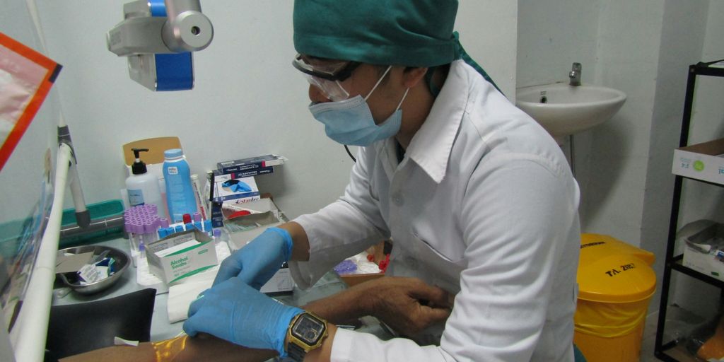 man in white dress shirt and red cap