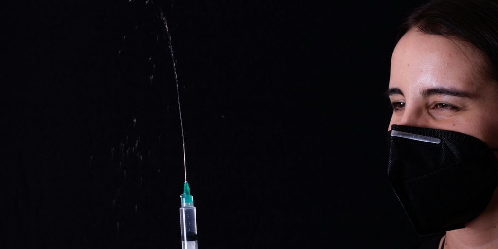 person holding green and black plastic tube