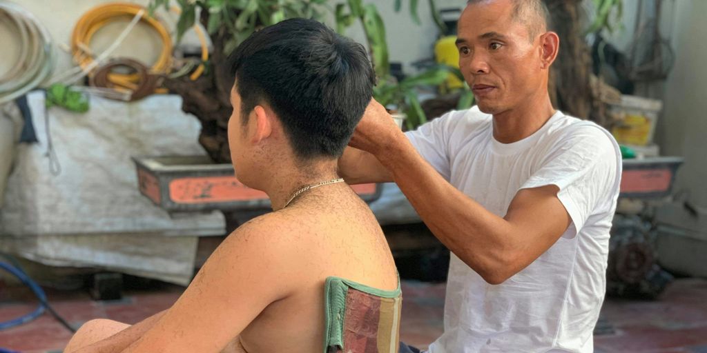 man in white crew neck t-shirt sitting beside man in white t-shirt