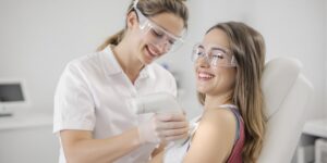Teen girl underarm laser treatment in a friendly clinic setting.