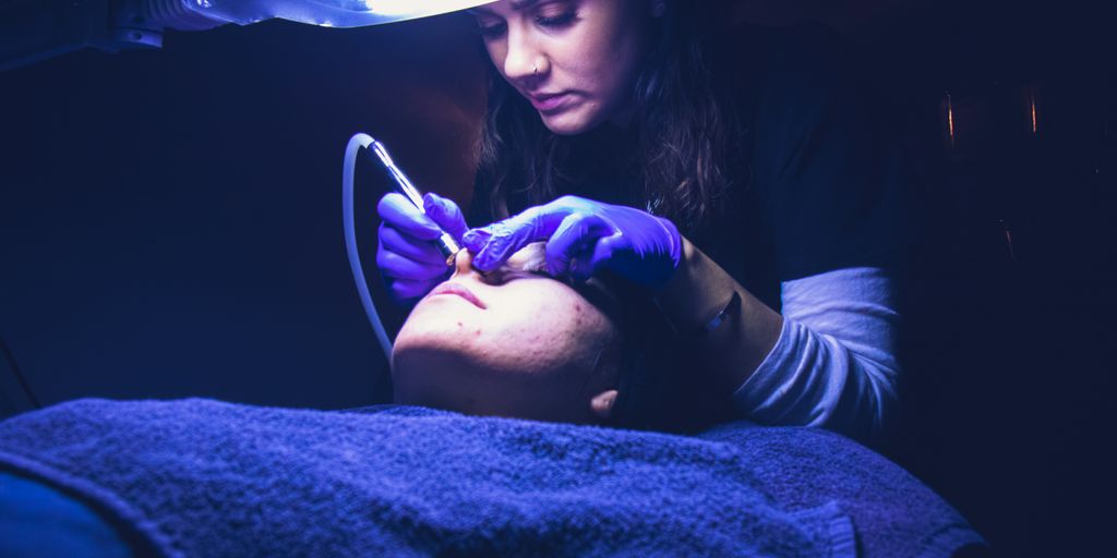 woman fixing another person's face